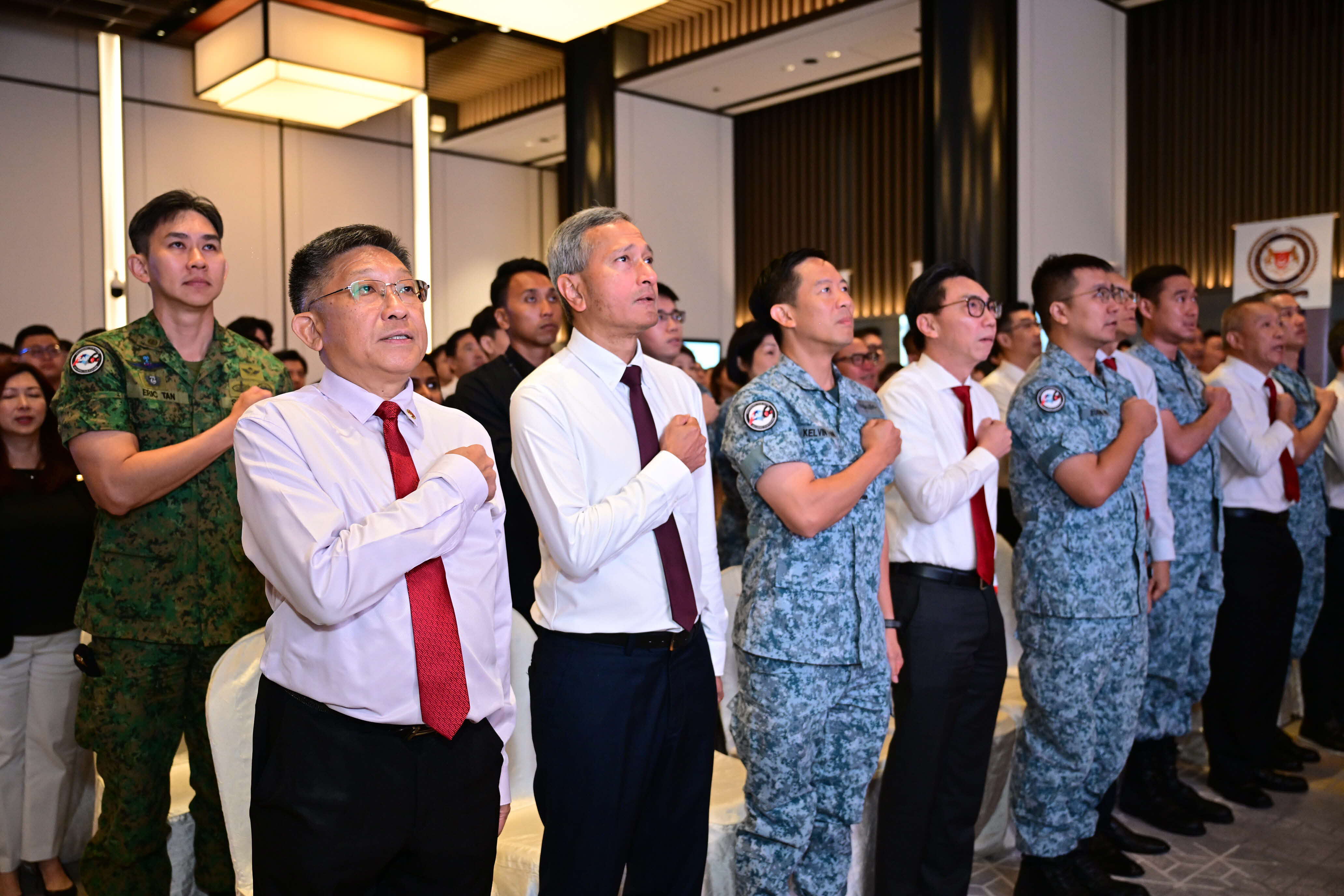 Group of seven people in business attire, standing beneath the "ERBER Group" logo and monitors showing produce.